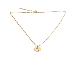 Detailed close-up of a golden stainless steel floral pendant with delicate engraved flower