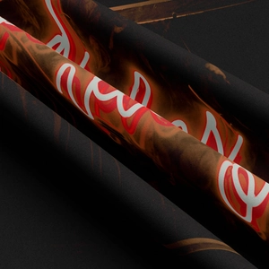 Macro shot showing premium knit texture and artistic flame lettering on black tapestry