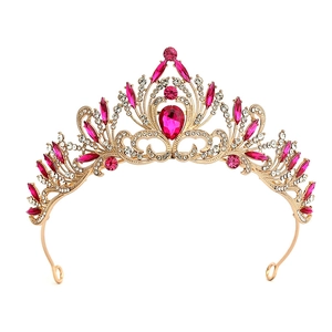 Detailed view of Baroque gold crown with fuchsia gemstones and crystals for brides