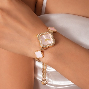 Close-up of a lucky clover watch with rhinestones and pink acetate on a woman's wrist
