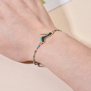 Bohemian gold bracelet with high heel pendant and light blue beads for women