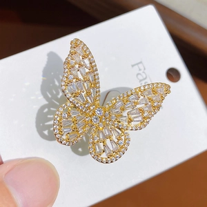 Macro detail of a butterfly ring with gold plating and sparkling zircon crystal inlays