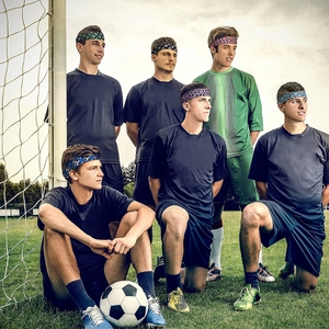 Athletic headbands for women with soccer patterns shown on players at a football field
