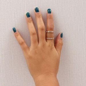 Close-up of model wearing two 18K gold plated stainless steel rings with zircon stones