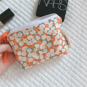 Macro detail of floral cotton mini pouch with zipper and Simple Wish woven label tag