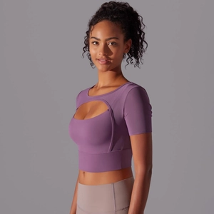 Close-up of purple yoga top featuring a unique hollow-out cut and breathable mesh texture