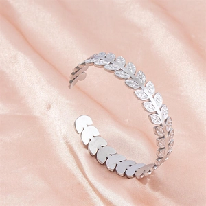 Adjustable silver leaf pattern stainless steel open cuff bracelet on pink silk fabric