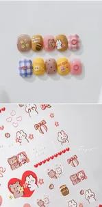 Detail of 3D embossed teddy bear nail stickers in pastel colors with heart patterns