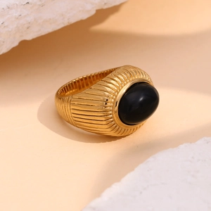 Detail of vintage 18K gold plated stainless steel ring with black onyx and ridge texture