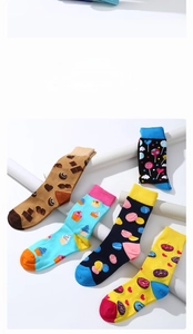 Detail view of cotton mid-calf socks with colorful cartoon food and candy patterns