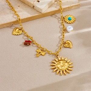Gold-plated vintage necklace with sun face, heart, bow, pearls and turquoise charms