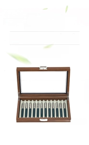 Detail of 12-slot brown wood grain pen display box with glass top and velvet lining
