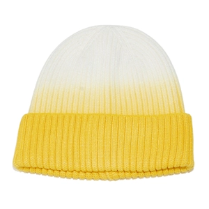 Detail of rib-knit texture and white to yellow gradient on a winter beanie hat