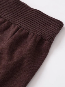 Detailed close-up of dark brown knit fabric texture with high-elastic ribbed cuff