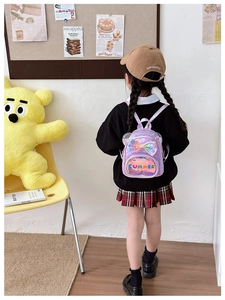 Detail of purple sequin princess backpack with transparent cat ears and bow for girls