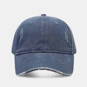 Detail of distressed navy denim baseball cap showing vintage worn texture and stitching