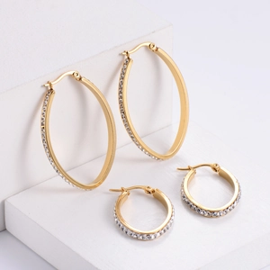 Gold-plated egg-shaped hoop earrings with sparkling rhinestones set on white blocks