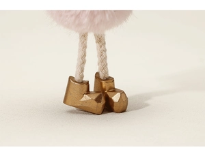 Detail of plush angel ornament featuring soft pink fur and golden boots for Christmas