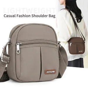 Chic nylon crossbody bag with adjustable wide strap and multiple zipper compartments