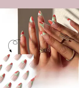 Detailed view of long stiletto press-on nails featuring red and green geometric color blocks
