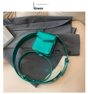 Detail view of mini green patent leather square bag on stylish neutral background