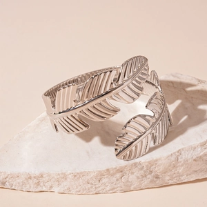 Detail of silver leaf shaped open cuff bracelet featuring intricate vein textures