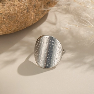 Polished silver stainless steel ring with hammered texture in an artistic minimalist style