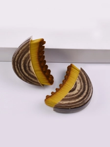 Detail of creative fan-shaped makeup brushes with wavy gradient bristles and tortoiseshell handles