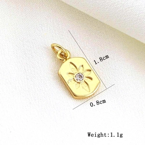 Detail of gold floral pendant with clear gemstone including size 1.8cm by 0.8cm and weight