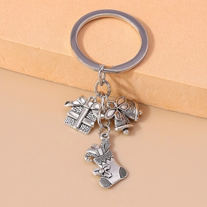 Detailed shot of retro silver metal keychain with gift box, bell, and Christmas sock charms