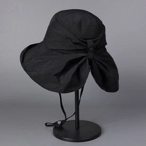 Detail of black wide brim sun hat featuring rear pleats and adjustable wind strap