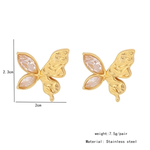Detail of butterfly earrings in gold stainless steel with zircon and matte finish