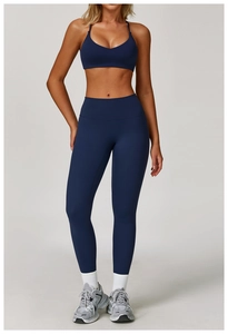 Detailed full-body shot of a dark blue high-waist yoga set and sports bra outfit