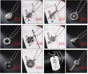 Macro display of twelve vintage hip-hop style pendant necklaces with silver-aged textures