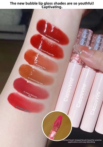 Swatches of mirror water gloss lip glazes on arm showing six vibrant hydrating shades