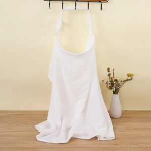 Detail showing soft white double-layer muslin cotton nursing cover on a wall hook