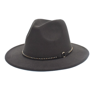 Detail of dark grey wool fedora featuring gold studs and metal buckle on leather band