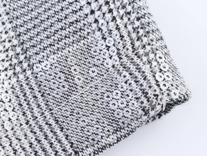 Λεπτομερής προβολή macro από ύφασμα houndstooth με πούλιες για το σετ πάρτι δύο τεμαχίων