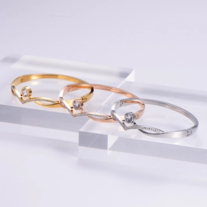 Close-up of three-tone crown bangles with large center zircon and pave accents