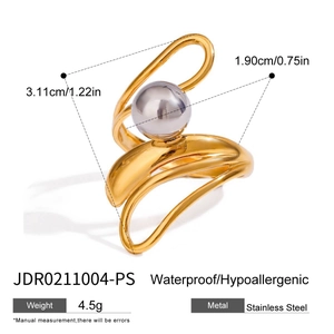 Detail of two-tone stainless steel wrap ring with gold band and silver ball design