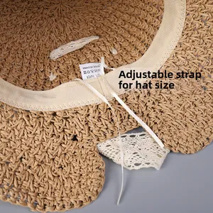 Detail of adjustable inner drawstring and lace trim on a woven straw sun hat
