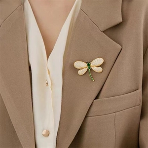 Exquisite crystal rhinestone dragonfly brooch pin detail, elegant lapel accessory.