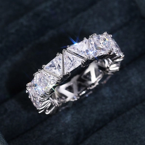 Macro shot of trillion cut full pavé eternity ring in blue velvet jewelry box