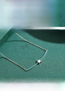 Macro detail of S925 sterling silver jewelry set featuring turquoise star pendant and ring