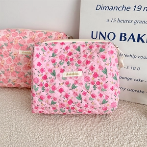 Detailed close-up of pink floral quilted fabric with tulip pattern and Sozakka label