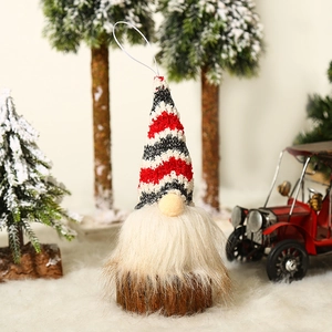 Christmas gnome ornament with red striped knit hat, white beard and wooden base