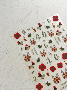 Detailed relief Christmas nail stickers featuring festive puppy, tree and floral motifs