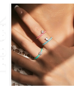 Close-up of three colorful S925 silver rings with round, pear, and square-cut zircons