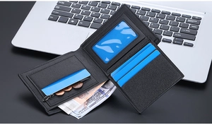 Detail view of black leather wallet with multiple card slots and zipper coin pocket