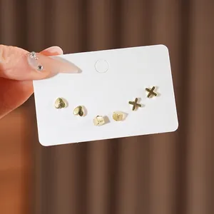 6-piece gold heart and geometric stud earring set on display with polished finish